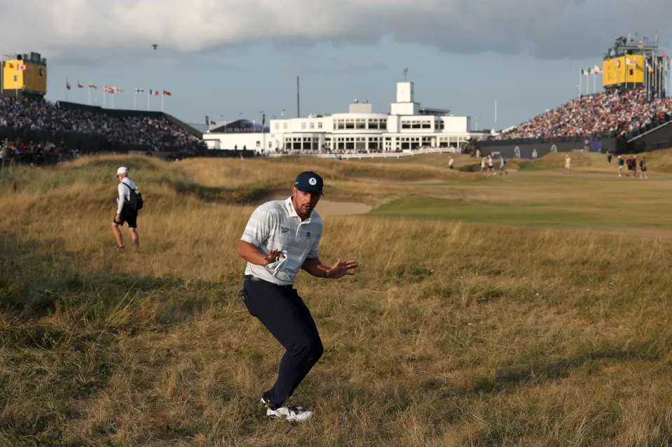 Bryson DeChambeau of the United States reacts to a rules official