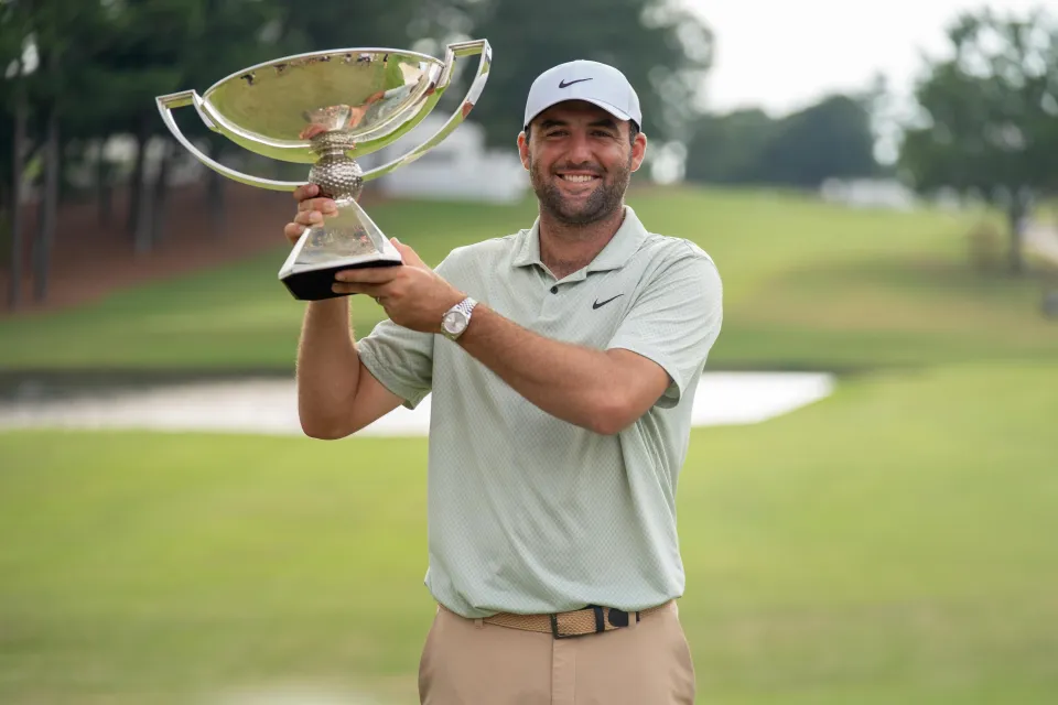 Scottie Scheffler holds aloft the Tour Championship trophy