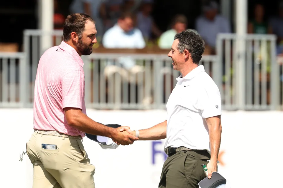 Scottie Scheffler of the United States shakes hands with Rory McIlroy