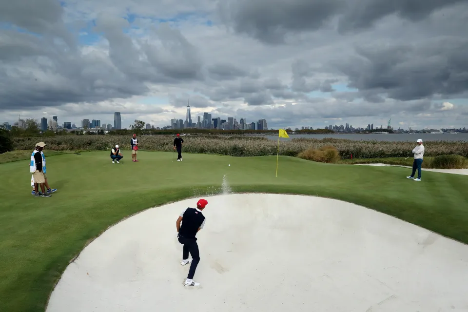 Dustin Johnson of the United States team plays his second shot on the 10th hole in his match with Brooks Koepka against Branden Grace and Marc Leishman of the International team during the Saturday afternoon fourball matches in the 2017 Presidents Cup
