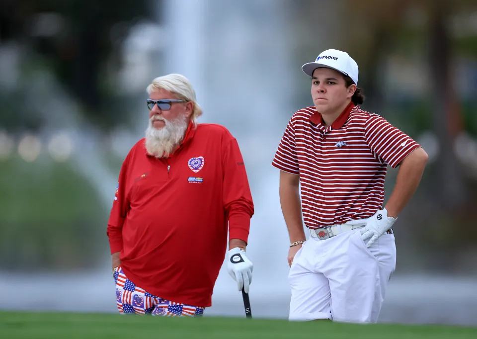 John Daly II of The United States the son of John Daly prepare to play their third shots on the 18th hole during the first round of the 2022 PNC Championship at The Ritz-Carlton Golf Club on December 17, 2022