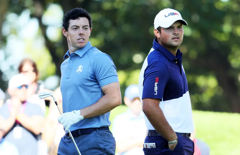 Rory McIlroy of Europe and Patrick Reed of the United States look on from the fourth tee during singles matches of the 2016 Ryder Cup