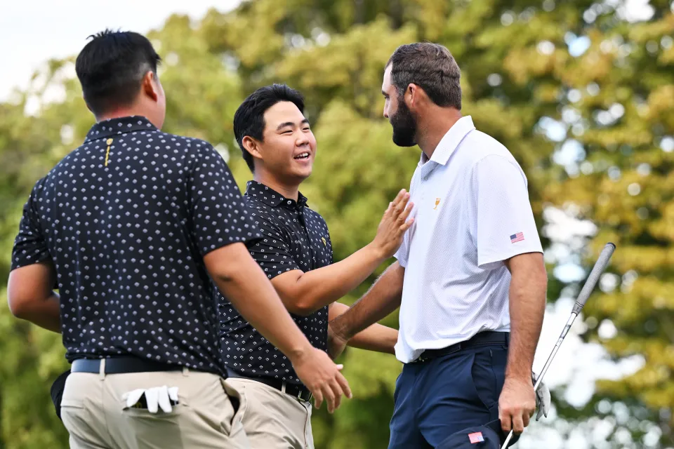 Tom Kim of South Korea and the International Team and Scottie Scheffler of the U.S. Team shake hands after Scheffler and Russell Henley defeated Kim and Sungjae Im 3&2 during Thursday's Four-ball matches on day one of the 2024 Presidents Cup