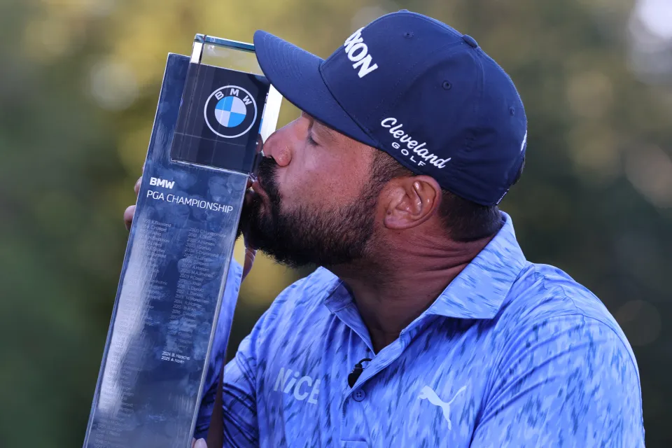 JJ Spaun kisses the trophy after his BMW PGA Championship success