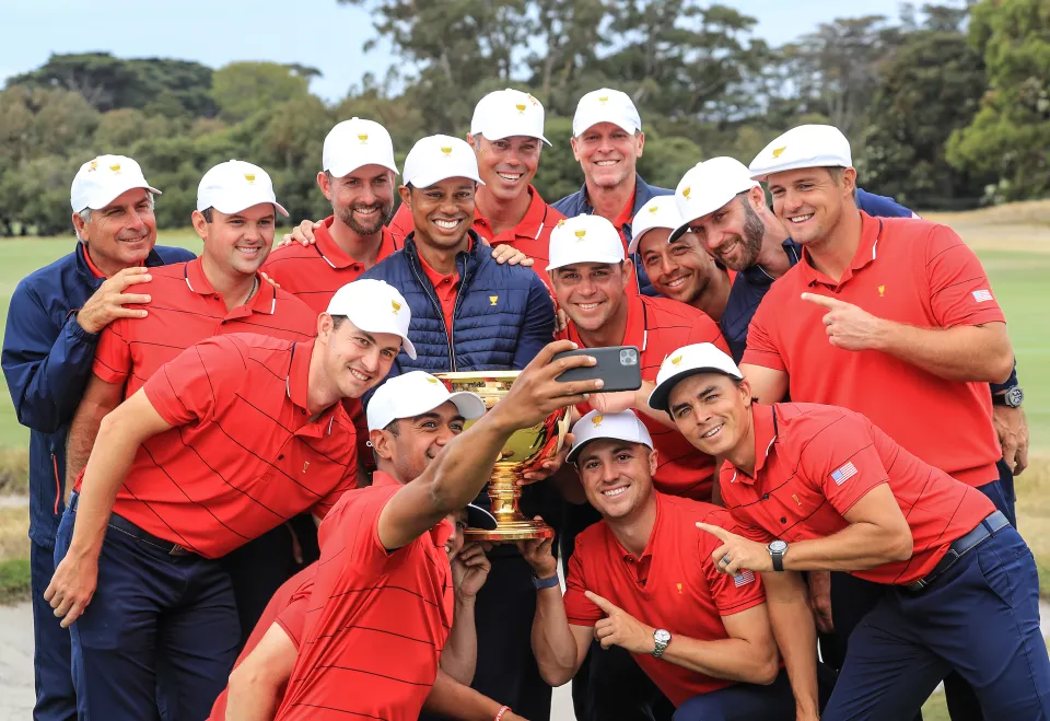 Tiger Woods the captain of the United States Team holds the Presidents Cup with his team as Tony Finau takes the team selfie after Woods had led his team to a 16-14 victory in the final day singles matches in the 2019 Presidents Cup
