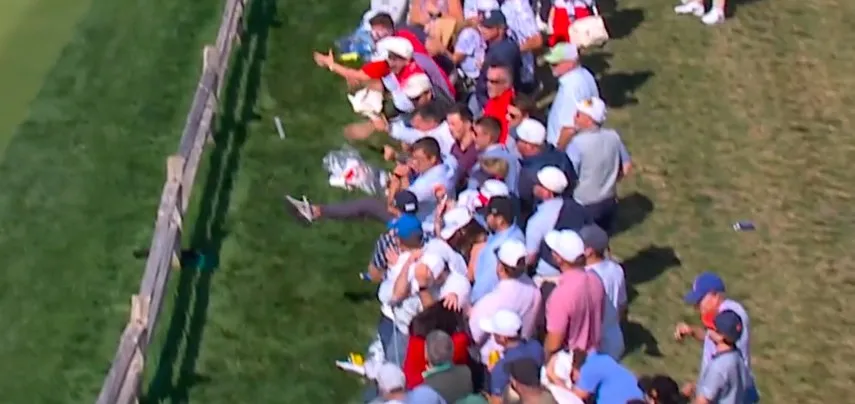 A golf fan at the Presidents Cup kicks Corey Conners' ball