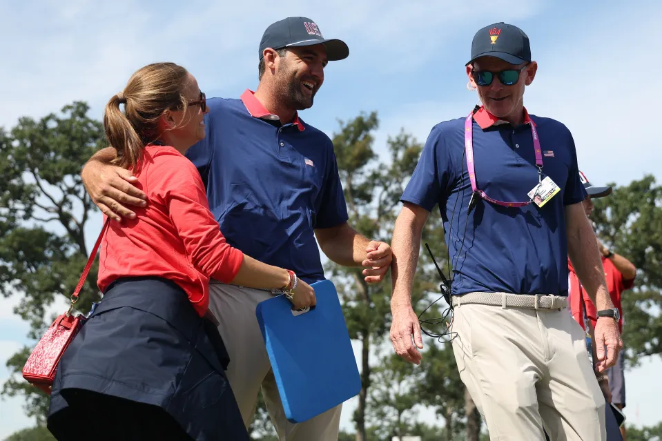Scottie Scheffler and Brandt Snedeker look on during the Presidents Cup