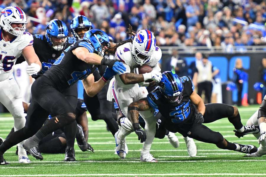 Bills running back James Cook tackled by Lions defenders Bills Lions